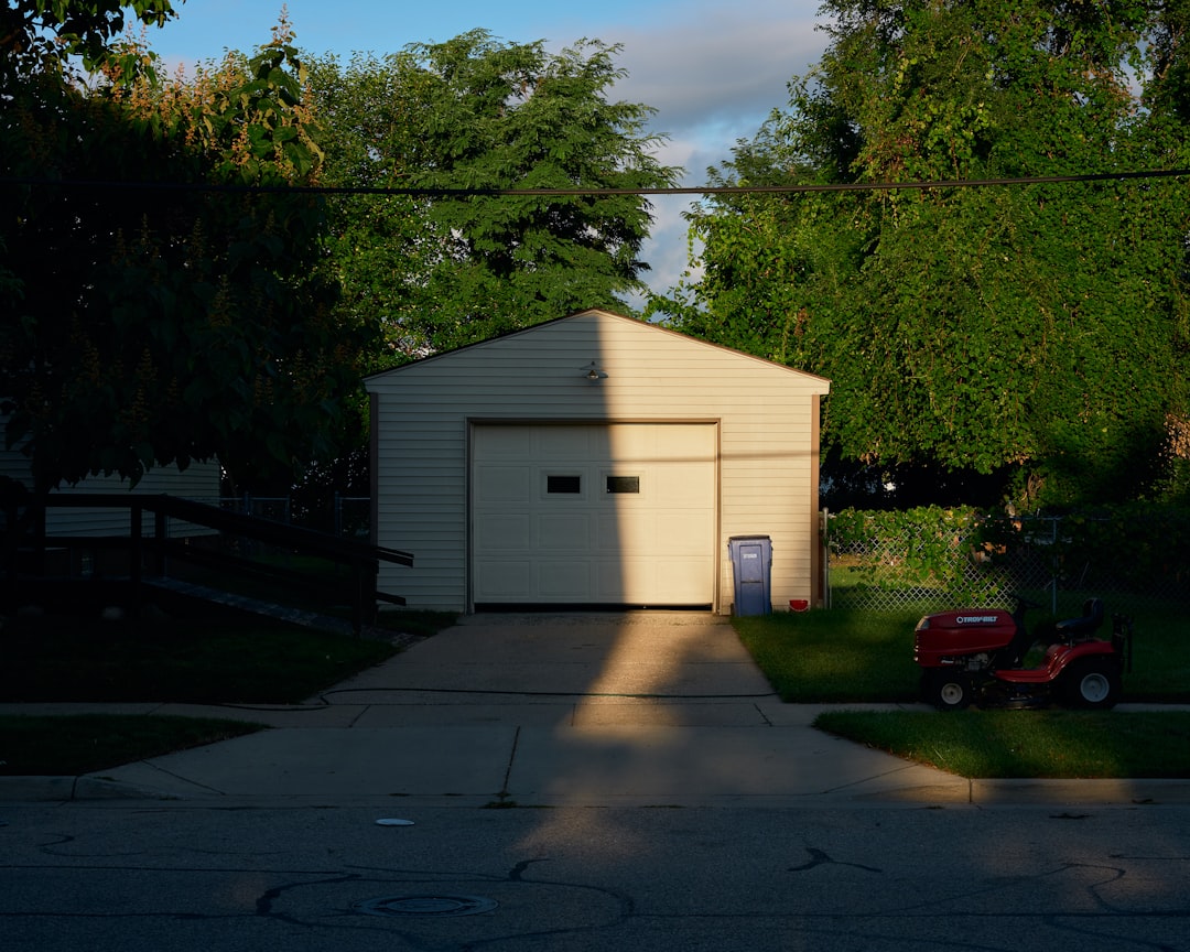 stats-img a-garage-with-a-lawn-mower-parked-in-front-of-it-omdnzfvr-l0